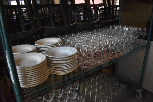 ALL ONE MONEY! Tier Lot of Approximately 47 Ceramic Pasta Plates, 38 Wine Glasses and 40 Champagne Glasses. Includes 9x9x1.5