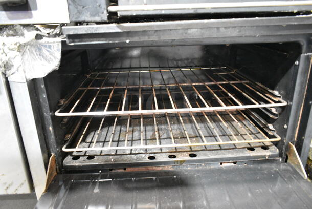 Garland Metal Commercial Natural Gas Powered 6 Burner Range w/ Flat Top Griddle, 2 Ovens, Back Splash and Over Shelf on Commercial Casters.  - Image 5 of 11