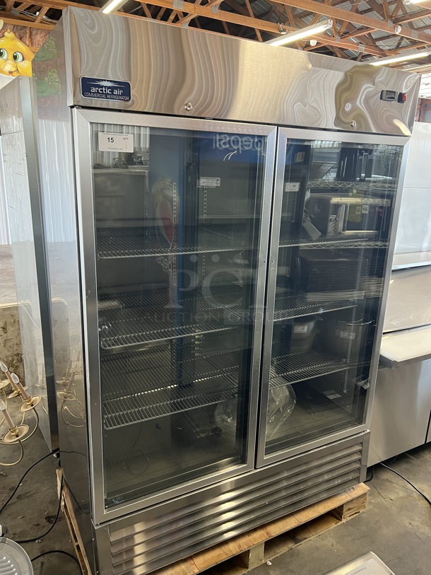 BRAND NEW SCRATCH AND DENT! Arctic Air AGR49 Stainless Steel Commercial 2 Door Reach In Cooler Merchandiser w/ Poly Coated Racks. 115 Volts, 1 Phase. Tested and Working!