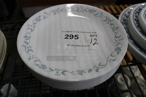12 White Ceramic Plates w/ Blue and Green Patterned Rim. 8.5x8.5x1. 12 Times Your Bid!