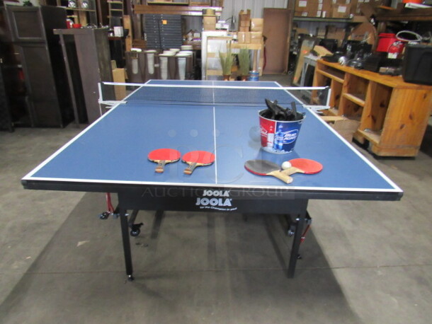 One Joola Ping Pong Table With Net, 4 Paddles, Ball, And Extra Net Brackets. 108X60X32