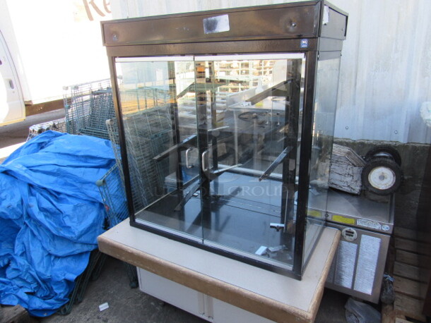 One Glass 2 Door Display Case With Self Closing Doors, On 2 Door Stand With Roll Out Shelves. 42X24X62 - Image 1 of 3