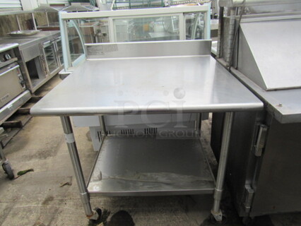 One Stainless Steel Table With A Stainless Under Shelf On Casters. 36X34X40