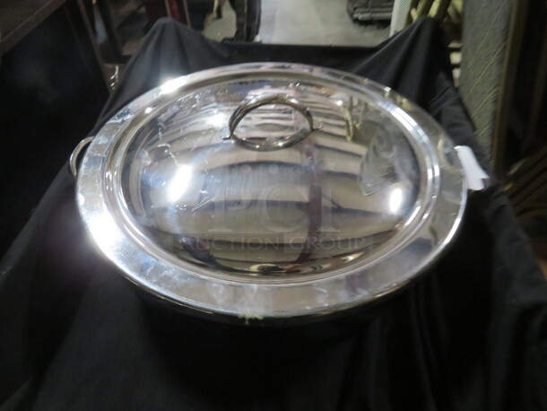 One 16 Inch Round Stainless Steel Pan With Lid.