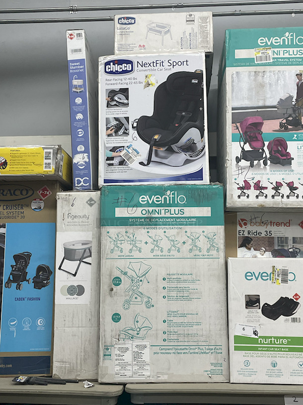 MASSIVE LOT! (3) Little Tikes 2-In-1 Snug & Secure Swings – 1 Blue, 2 Pink; (17) Nuby Water Resistant Baby Bibs (assorted colors); (1) Graco “Caden Fashion” Comfy Cruiser™ Travel System With Snugride® 30; (1) Allen YOOGO CZ2 Convertible Cargo Trailer → Handy Pull Cart,  (1) Delta Children Sweet Slumber Bassinet, (1) Chicco LullaGo Portable Bassinet, (1) Chicco NextFit Sport Convertible Car Seat, (2) Evenflo Omni Plus Modular Travel System – Includes LITEMAX Rear-Facing Infant Car Seat, (1) Baby Trend EZ Ride Girl 35 - Includes NEW 4-35 Ibs Infant Car Seat , (1) Evenflo Nurture Infant Car Seat Base. 11x Your Bid - Image 5 of 12