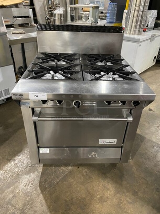 Garland Commercial Natural Gas Powered 4 Burner Stove! With Back Splash! With Oven Underneath! Metal Oven Rack! All Stainless Steel! On Casters! Model: M44R SN: 1601100100589
