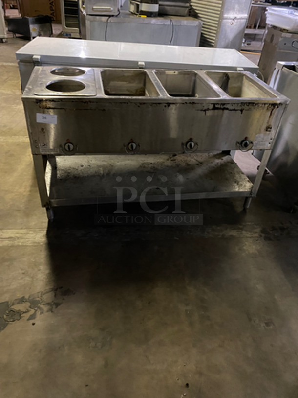 Duke 4 Well Steam Table! With Round Pan Adapter! With Storage Shelf Underneath! All Stainless Steel! On Legs! Model: E304M SN: 0214021 240V 60HZ 1 Phase