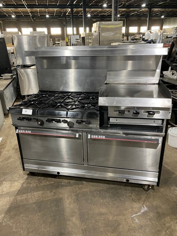 AMAZING! Garland Commercial Natural Gas Powered 6 Burner Split Top With Right Side Flat Griddle! With 2 Full Ovens Underneath! With Back Splash & Overhead Salamander Shelf! All Stainless Steel! With Metal Oven Racks! On Casters!  - Image 1 of 12