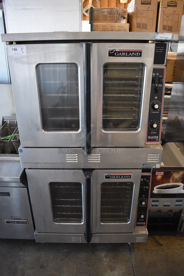 2 Garland Master 200 Stainless Steel Commercial Natural Gas Powered Full Size Convection Oven w/ View Through Doors, Metal Oven Racks and Thermostatic Controls on Commercial Casters. 38x38.5x70. 2 Times Your Bid!