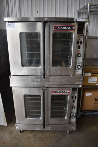 2 LATE MODEL Garland Master 200 Stainless Steel Commercial Electric Powered Full Size Convection Ovens w/ View Through Doors, Metal Oven Racks and Thermostatic Controls on Commercial Casters. 208 Volts, 3 Phase. 38x38x70. 2 Times Your Bid!