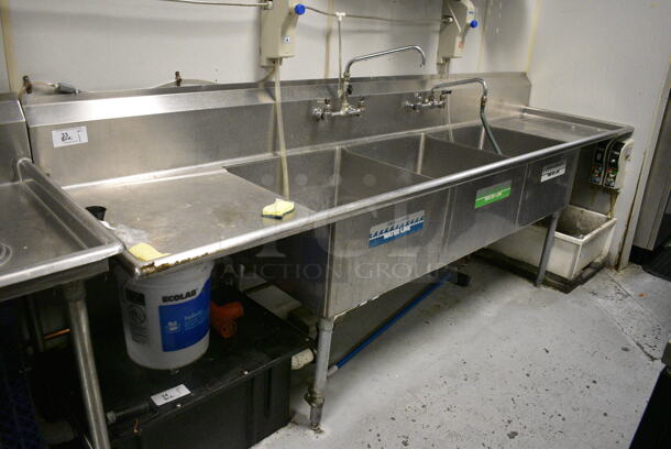 Stainless Steel Commercial 3 Bay Sink w/ Dual Drain Boards, 2 Faucets and 2 Handle Sets. 120x30x44. Bays 24x24x14. Drain Boards 23x26x2. BUYER MUST REMOVE. (kitchen)
