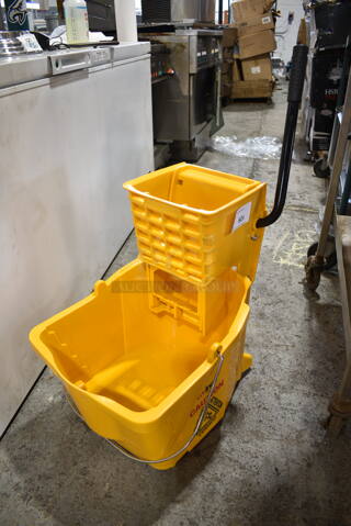 Winco 520 Yellow Poly Mop Bucket w/ Wringing Attachment and Commercial Casters. 