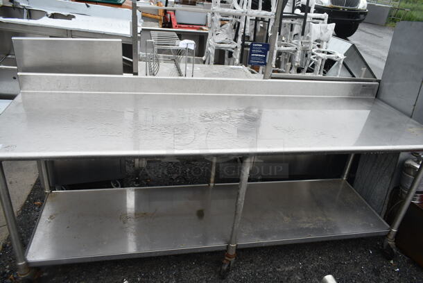 Eagle Stainless Steel Commercial Table w/ Back Splash and Under Shelf on Commercial Casters.  - Image 1 of 4