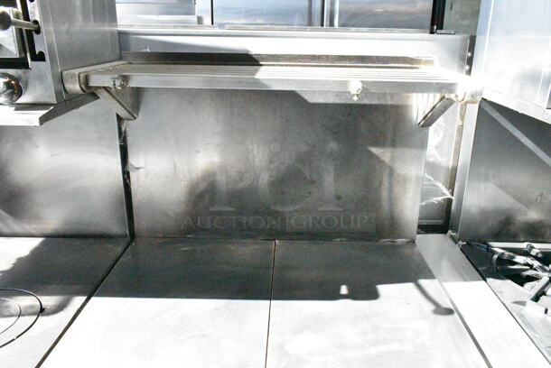 Garland M45R Stainless Steel Commercial Natural Gas Powered Flat Top w/ Oven, Over Shelf and Back Splash on Commercial Casters.  - Image 2 of 8