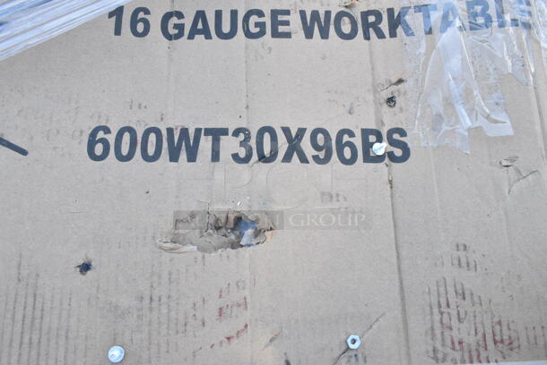 BRAND NEW SCRATCH AND DENT! Regency 600WT30X96BS 30" x 96" 16-Gauge 304 Stainless Steel Commercial Open Base Work Table with 4" Backsplash. May Be Missing Pieces.  - Image 3 of 3