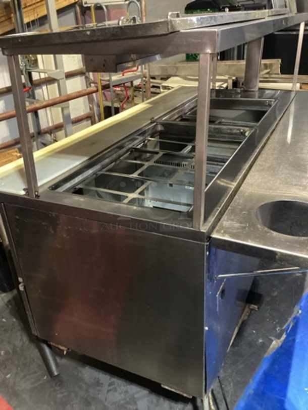 Randell Stainless Steel Dual-Sided Refridgerated Work Island, Multi-Pan Prep Table W/Two -Door and Two Drawers  Refrigerated Storage. Tested And Working. 84 x  46/52 x 58.
 - Image 1 of 11
