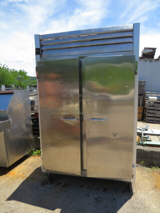 One Traulsen 2 Door Freezer With 6 Racks On Casters. WORKING WHEN REMOVED. 115 Volt. Model# G22010. 52.5X32X83.5
