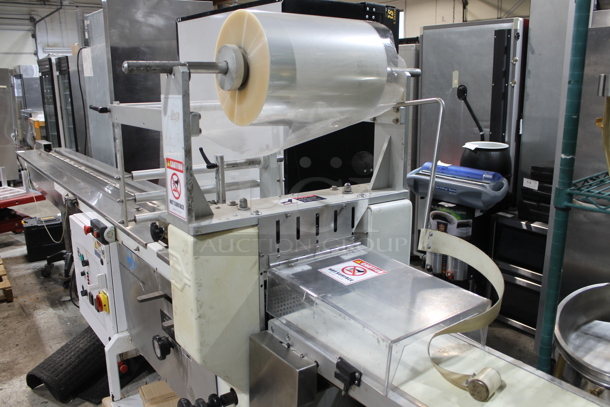 PFM Packaging 30 M Metal Commercial Floor Style Horizontal Form Fill and Seal / Horizontal Flow Wrapper Machine on Commercial Casters. 220 Volts, 1 Phase.  - Image 3 of 11