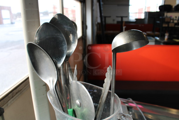 ALL ONE MONEY! Lot of Various Metal Utensils Including Serving Spoons, Ladle and Tongs in Clear Poly Pitcher.  - Image 3 of 4