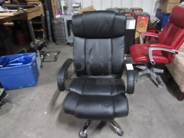One Black Pleather  Office Chair On Casters.