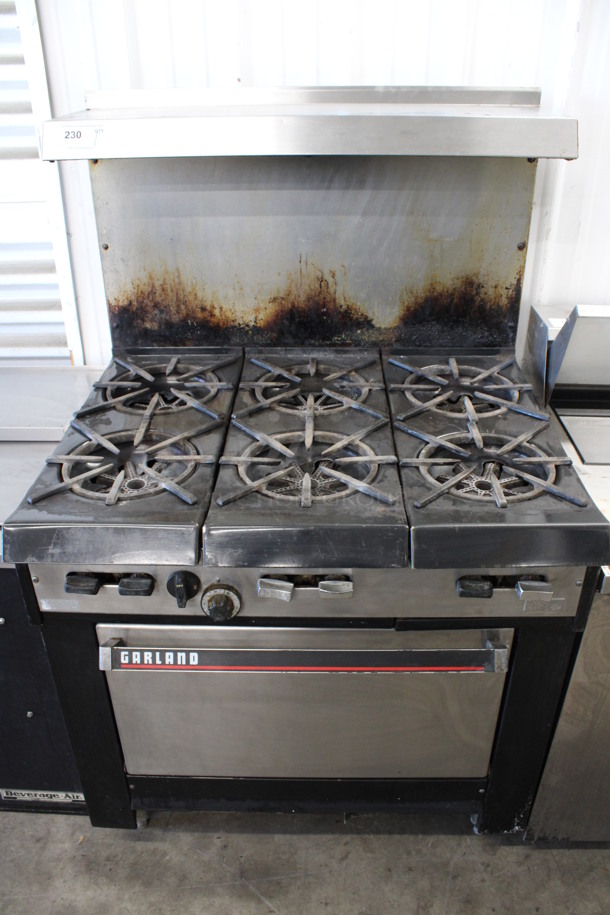 Garland Model K12 Stainless Steel Commercial Natural Gas Powered 6 Burner Range w/ Oven and Over Shelf. 36x31x60