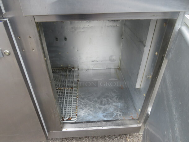 One Stainless Steel Traulsen 2 Section Half Door Refrigerator With 3 Racks On Casters. Model# G2000. 115 Volt. 52X35X83 - Image 2 of 3
