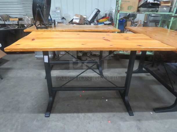 One Wooden Table Top On A Bar Height Black Industrial Base. 72X33X42