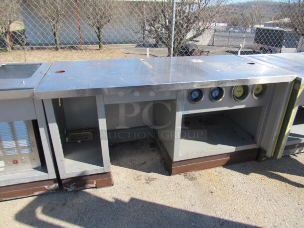 One Stainless Steel Work Table With 4 Spring Loaded Cup Dispensers, And Under Storage. 72X33.5X37.5