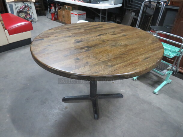 One Round Solid Wooden Table Top On A Pedestal Base. 42X42X29