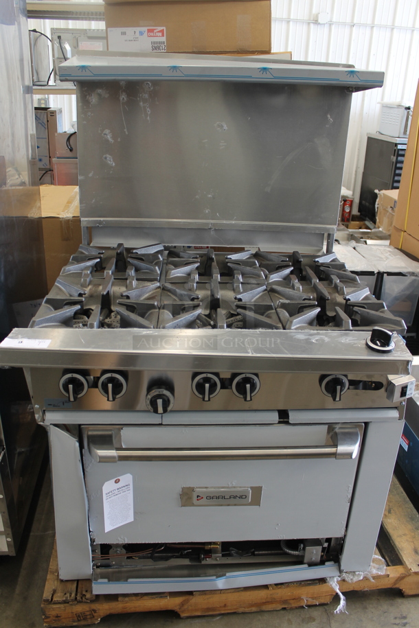 BRAND NEW SCRATCH AND DENT! LATE MODEL! Garland Stainless Steel Commercial Natural Gas Powered 6 Burner Range w/ Convection Oven, Over Shelf and Back Splash.  - Image 1 of 8