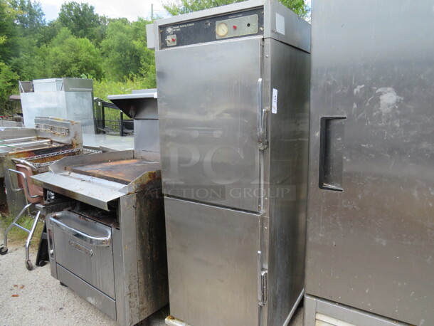 One Stainless Steel Henny Penny Holding Cabinet, On Casters. Missing 1 Knob. Model# HC900. 26.5X30X70