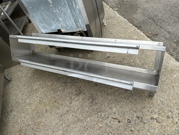 One Stainless Steel Double Wall Mount Shelf, With 2 -48 Inch Ticket rails Attached. 60X12X19 - Image 1 of 1