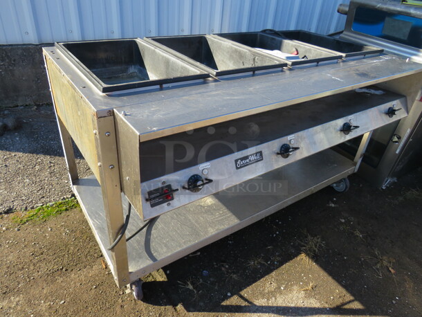 One WORKING Vollrath Serve Well Electric Four Pan Hot Food Table With Stainless Steel Under Shelf On Casters. 120 Volt. Model# 38004. 60.5X32X35. $2323.40.  - Image 2 of 2