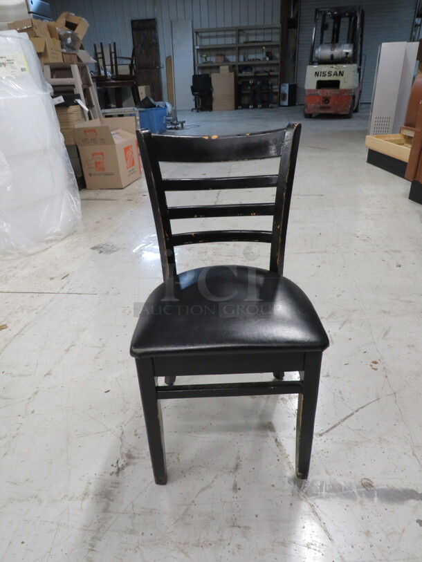 Black Wooden Chair With A Black Cushioned Seat. 4XBID
