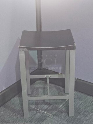 Stools. Silver finish metal framing with wooden black seat. Has wear and scratches on the seat as well as some on the frame but in good condition! Measures 24.5” H x 15.5” W x 14” D. BIDX8

