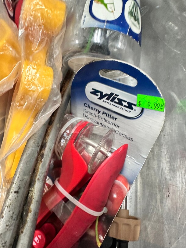 One Lot Of Kitchen Items Includes Dressing Mixer Cherry Pitter and Other Items  - Image 1 of 8