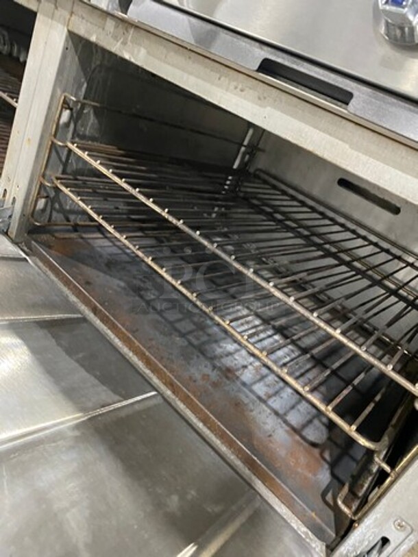 Patriot Commercial Natural Gas Powered 6 Burner Stove With Flat Griddle! Flat Griddle Has Side Splashes! With Raised Back Splash! With 2 Oven Underneath! Metal Oven Racks! All Stainless Steel! On Casters! Model: FMGR6024GNG SN: 17035100006 - Image 9 of 12