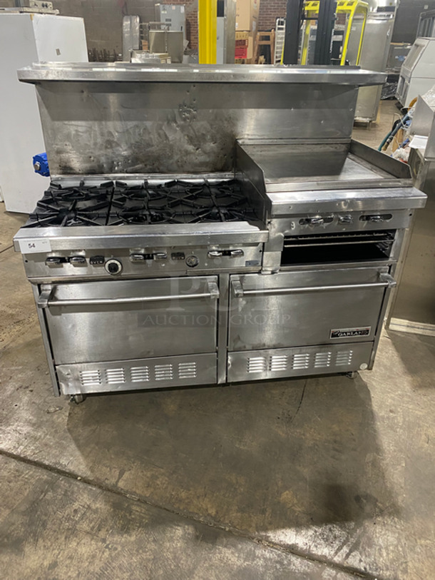 GREAT FIND! Garland Commercial Gas Powered 6 Burner Stove With Right Side Flat Griddle! Griddle Has Side Splashes! With Raised Back Splash And Salamander Shelf! With 2 Oven Underneath! Metal Oven Racks! All Stainless Steel! On Casters!