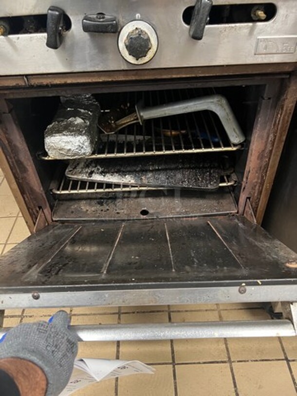 Garland Commercial Natural Gas Powered 4 Burner Stove! With Raised Back Splash And Salamander Shelf! With Oven Underneath! Metal Oven Rack! All Stainless Steel! On Legs! WORKING WHEN REMOVED! - Image 3 of 6