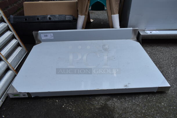 BRAND NEW SCRATCH AND DENT! Regency 600WT24X36BS 24" x 36" 16-Gauge 304 Stainless Steel Commercial Open Base Work Table with 4" Backsplash. No Legs. - Image 2 of 3