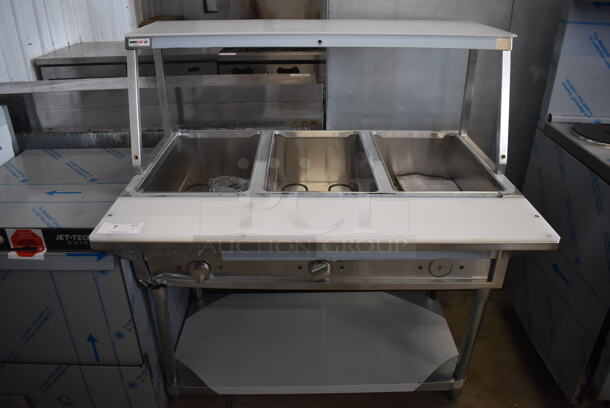 BRAND NEW SCRATCH AND DENT! ServIt 423EST3WO Stainless Steel Commercial Electric Powered Three Pan Open Well Steam Table with Angled Sneeze Guard and Casters. 120 Volts, 1 Phase. 