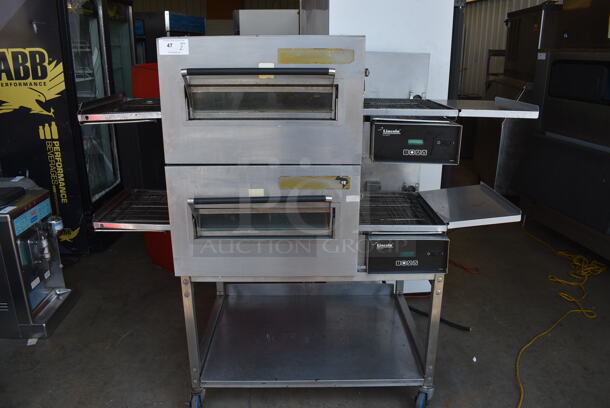 2 Lincoln Impinger Stainless Steel Commercial Electric Powered Conveyor Pizza Oven on Commercial Casters. 120/208 Volts, 3 Phase. 69x36x62.5. 2