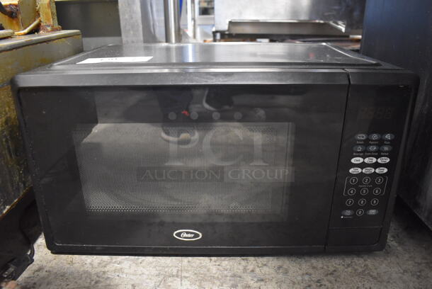 Oster OGCMF211BK-10 Microwave Oven w/ Plate. 120 Volts, 1 Phase.