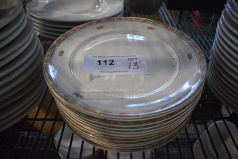 13 White Ceramic Plates w/ Floral Rim. 10x10x1. 13 Times Your Bid!