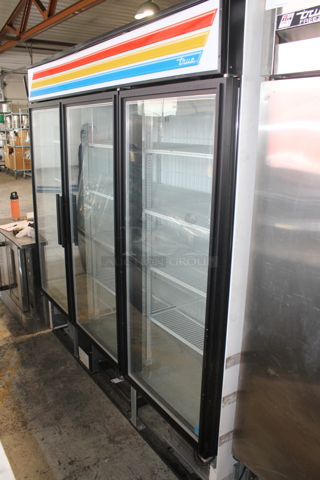 2016 True GDM-72F-HC-LD ENERGY STAR Metal Commercial 3 Door Reach In Freezer Merchandiser w/ Poly Coated Racks. 115/208-230 Volts, 1 Phase. 