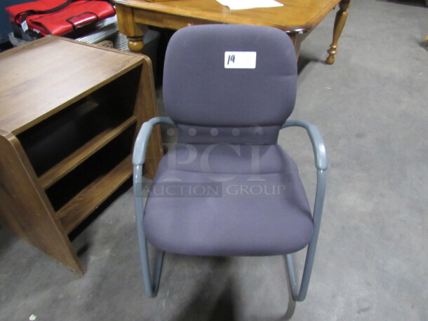 One Metal Framed Office Arm Chair With Purple Cushioned Seat And Back.