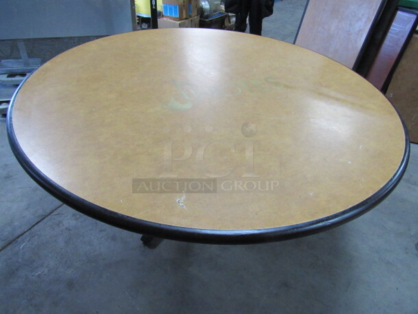 One 48 Inch Round Beige Table Top With The NOTES Logo On A Pedestal Base. 48X48X30