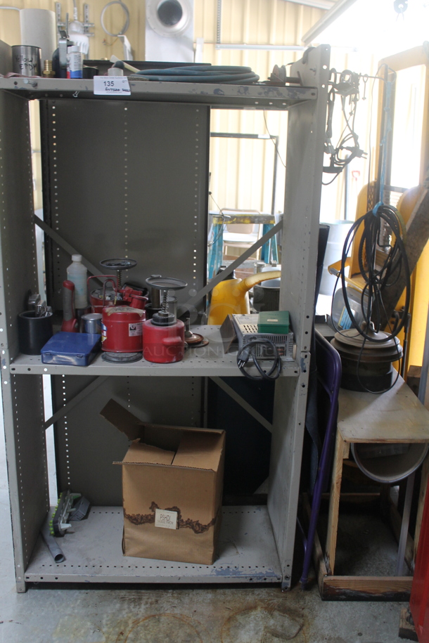 Gray Metal 3 Tier Shelving Unit and Wooden Table w/ Contents Including Iota DLS-27-40 Battery Charger. BUYER MUST REMOVE. - Image 1 of 6