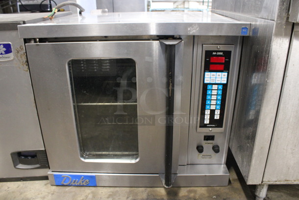 Duke IM-2000 Stainless Steel Commercial Electric Powered Half Size Convection Oven w/ Metal Racks. 208-250 Volts, 1 Phase. 30x28.5x26.5