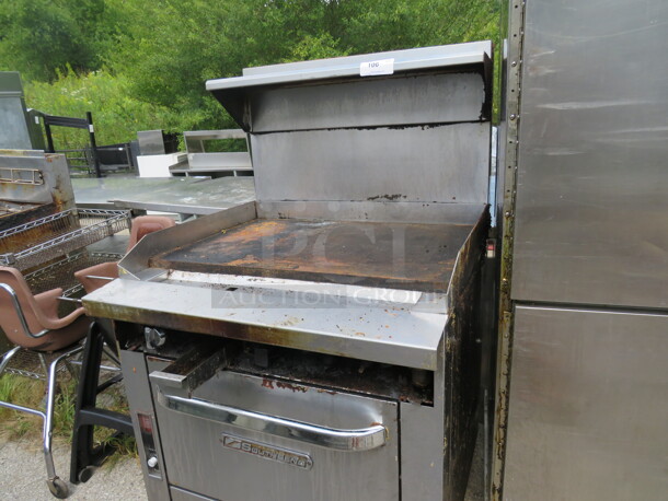 One Southbend Flattop Range With Stainless Steel Overshelf On Casters. Missing 2 Knobs, And Front Panel. 36X38X60